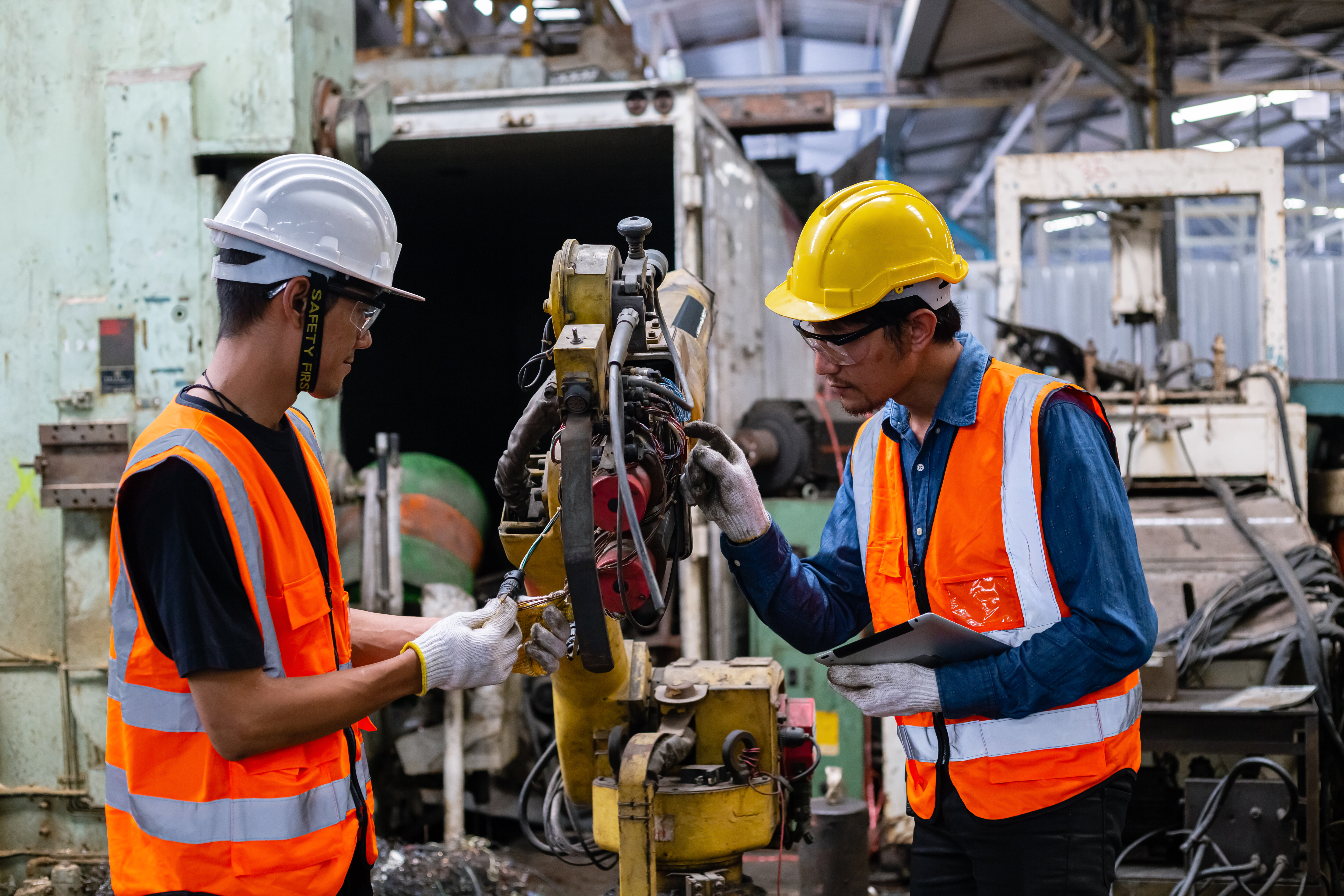 engineering team worker wearing uniform safety and hardhat working machine lathe metal.
